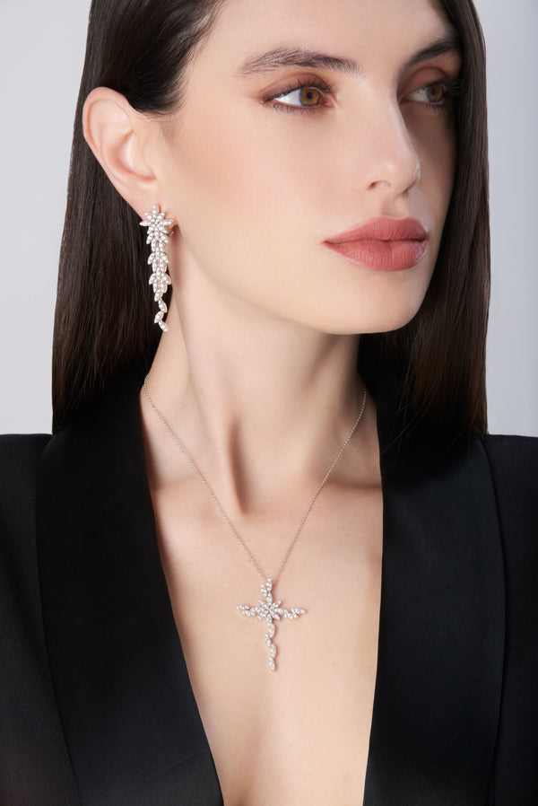 Dangle earrings with diamonds in 18k white gold worn by model in black jacket
