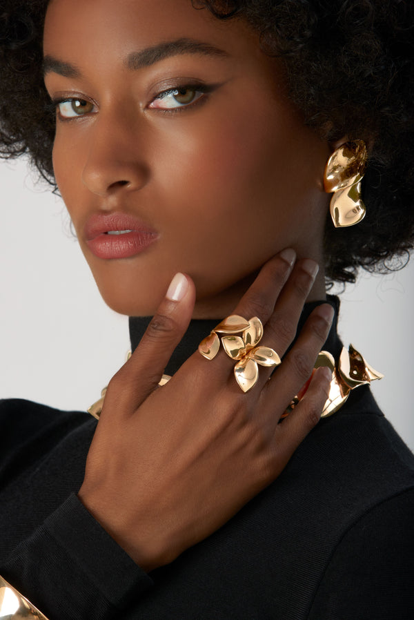 Ring, earrings in 18k Rose Gold on model wearing black turtleneck