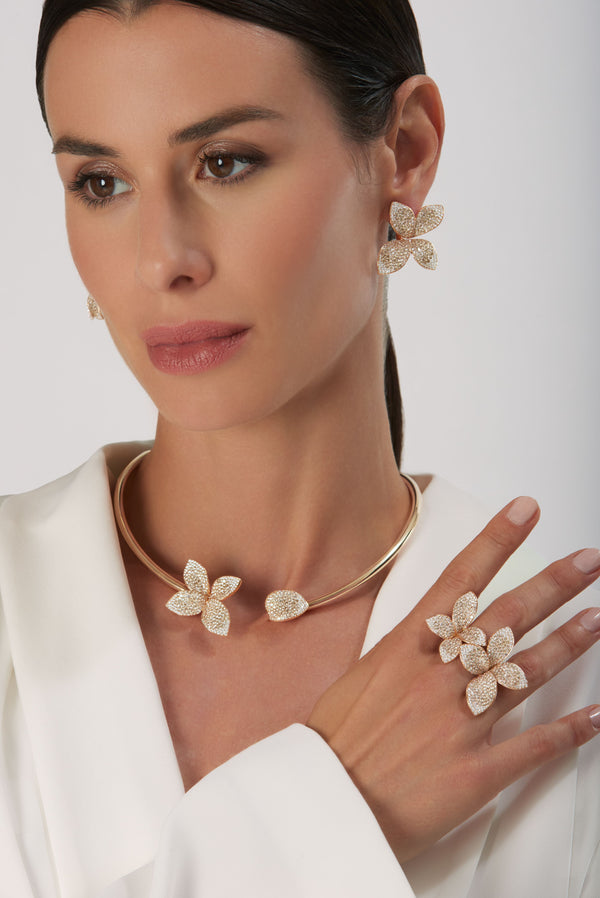 Earrings, rings and necklace in 18k Rose Gold with White and Champagne Diamonds on model wearing white shirt