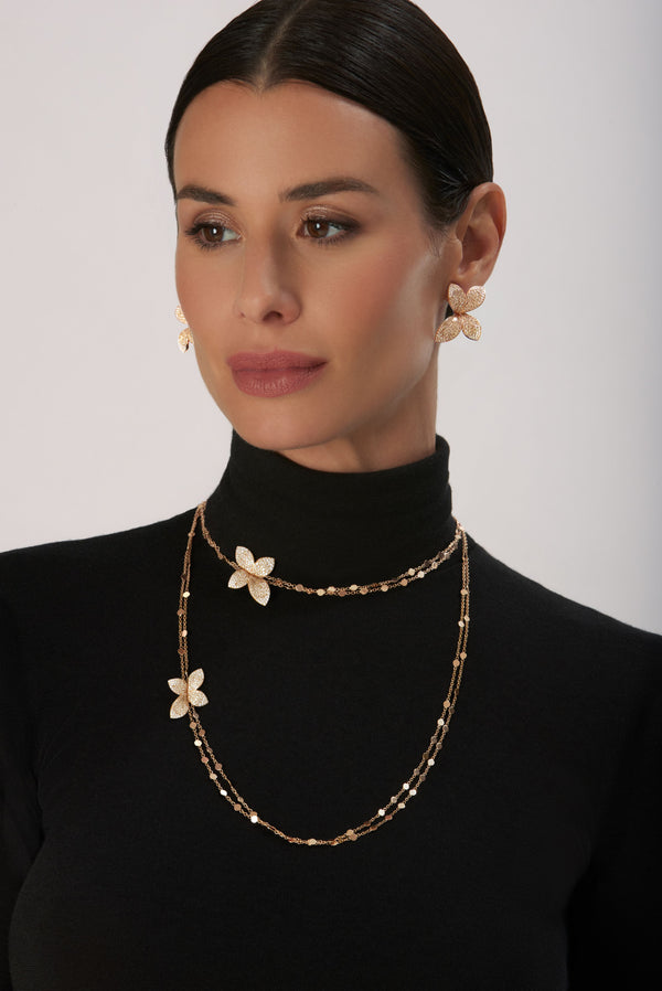 Sautoir and earrings in 18k Rose Gold with White and Champagne Diamonds on model wearing a black turtleneck