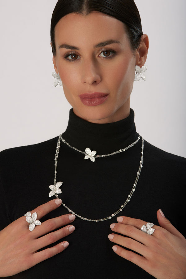 Sautoir, rings and earrings in 18k White Gold with Diamonds on model wearing black turtleneck