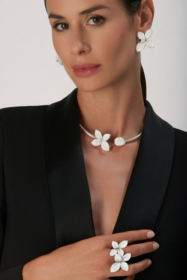 Double Flower Ring, earrings and collier in 18k White Gold with Diamonds on model wearing black jacket.