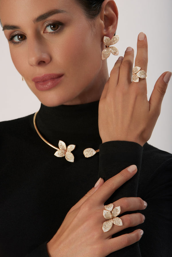Earrings, rings and necklace in 18k Rose Gold with White and Champagne Diamonds on model wearing black shirt.