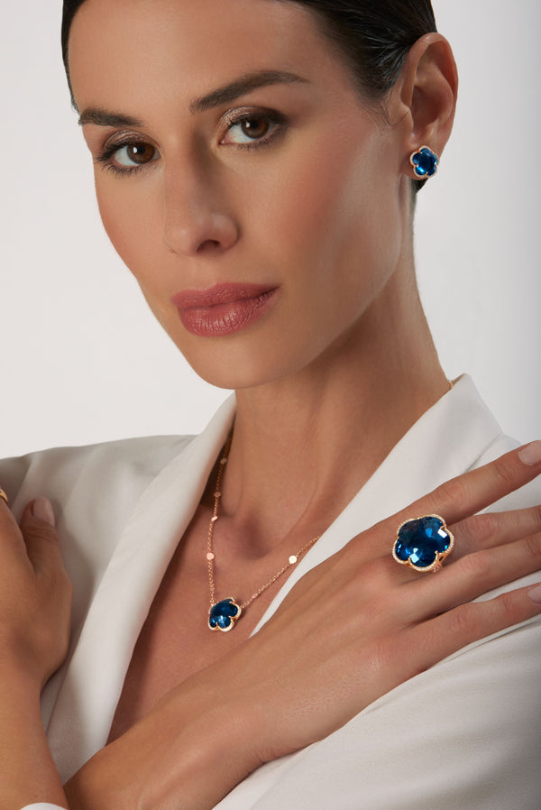 Stud Earrings, necklace and ring in 18k Rose Gold with London Blue Topaz and Diamonds on model wearing a white shirt