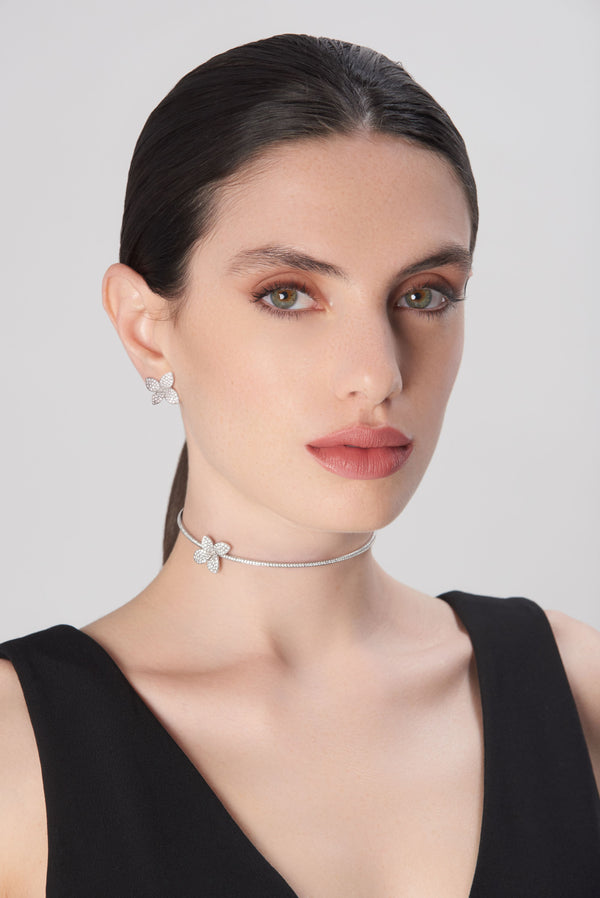 Choker and stud earrings in 18k white gold with diamonds on model in black dress