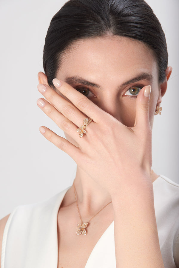 Necklace and ring in 18k rose gold with diamonds on model wearing ivory dress