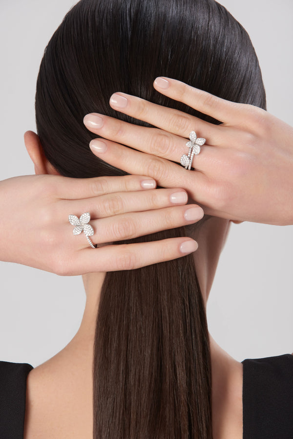 Ring on model's finger in 18k white gold with diamonds, black dress