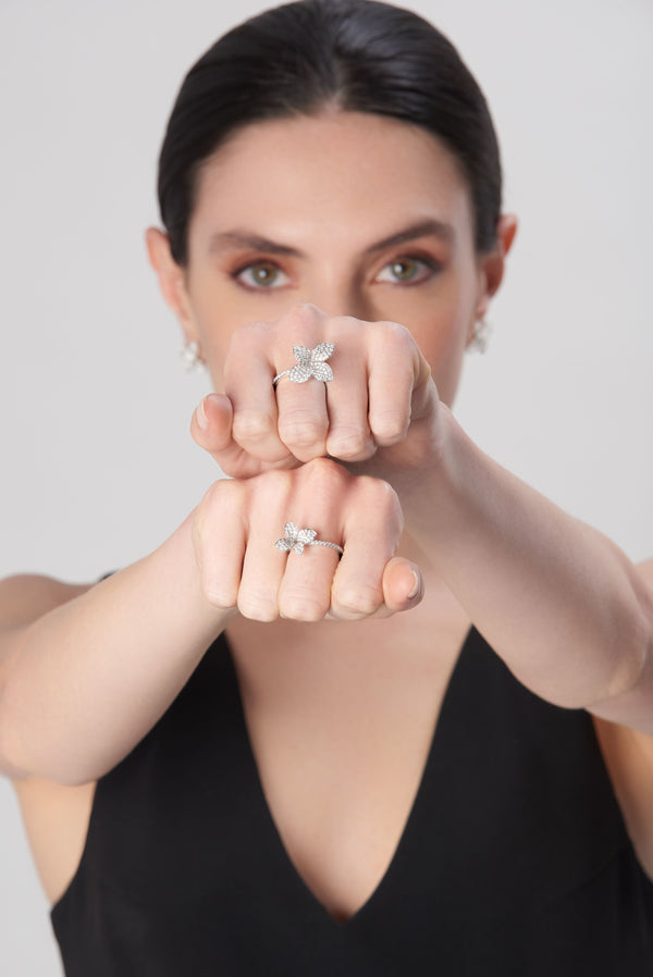 Ring on model's finger in 18k white gold with diamonds, black dress