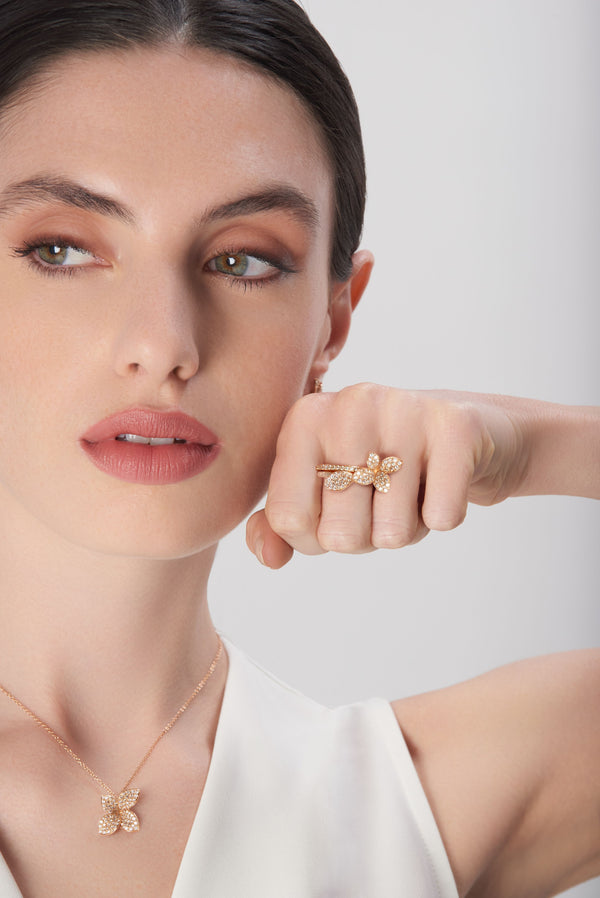 Necklace and ring in 18k rose gold with diamonds on model wearing white dress