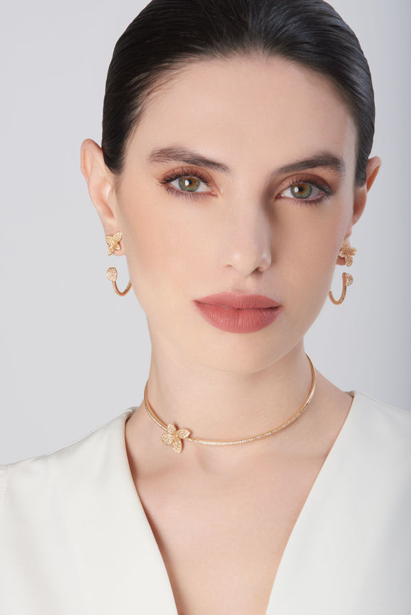 Choker and earrings in 18k Rose Gold with Diamonds on model wearing white dress.