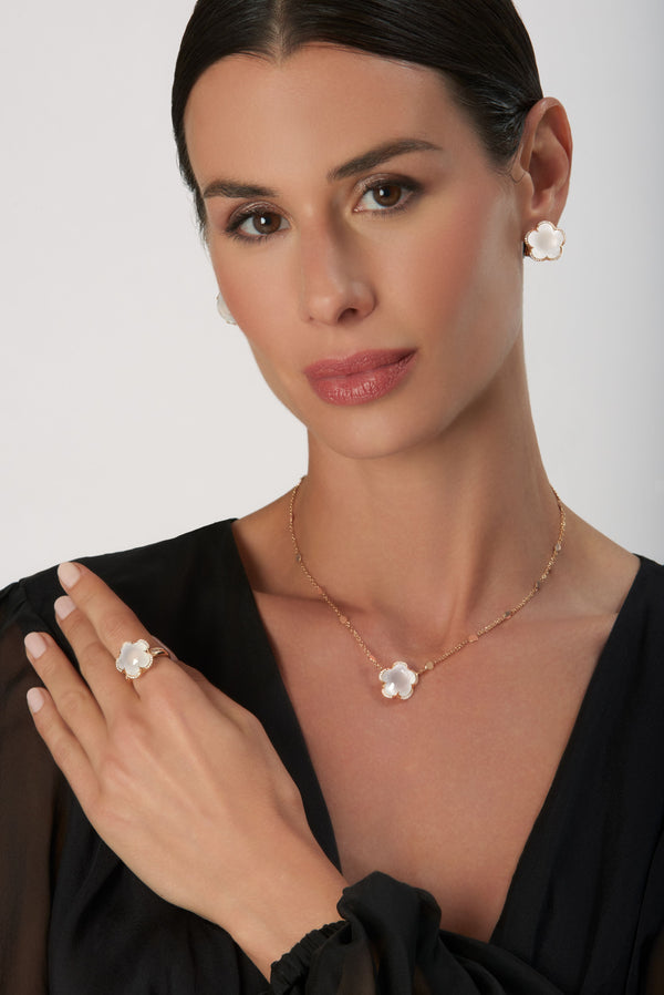 Necklace, ring and earrings in 18k Rose Gold with Milky Quartz and Diamonds on model wearing black dress.