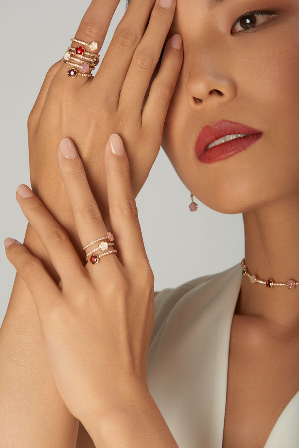 Choker and rings in 18k rose gold with coloured stones on model in silk blouse