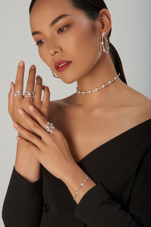 Jewelry set in 18k white gold with white and champagne diamonds on model