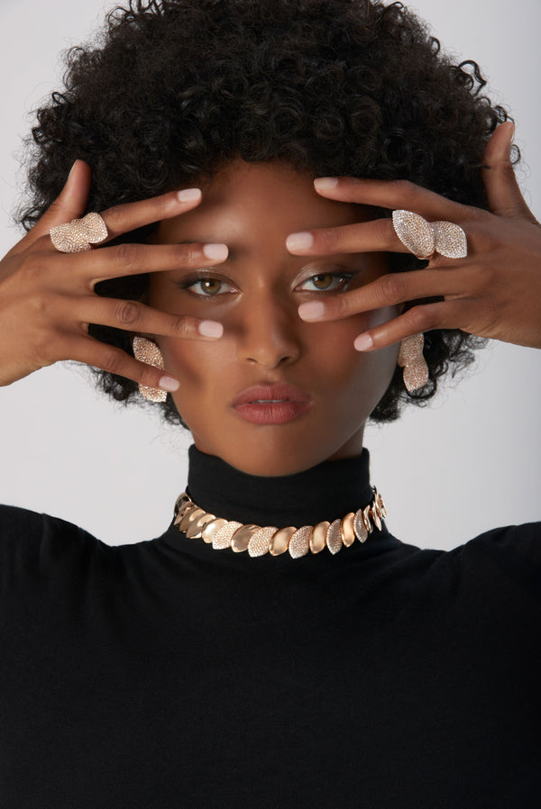 Choker Combination in 18k Rose Gold and Velvet with White and Champagne Diamonds and rings and earrings on model wearing black turtleneck