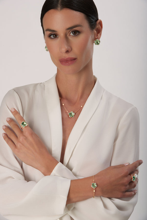 Necklace, rings, bracelet and earrings in 18k Rose Gold with Prasiolite and Diamonds on model wearing a white dress