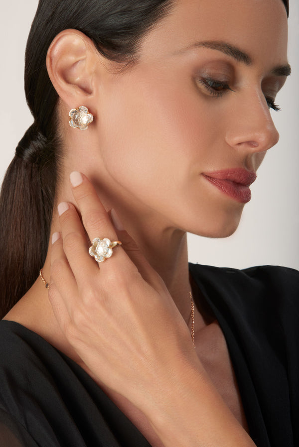 Ring and earrings in 18k Rose Gold with Rock Crystal, White and Champagne Diamonds on model wearing black dress