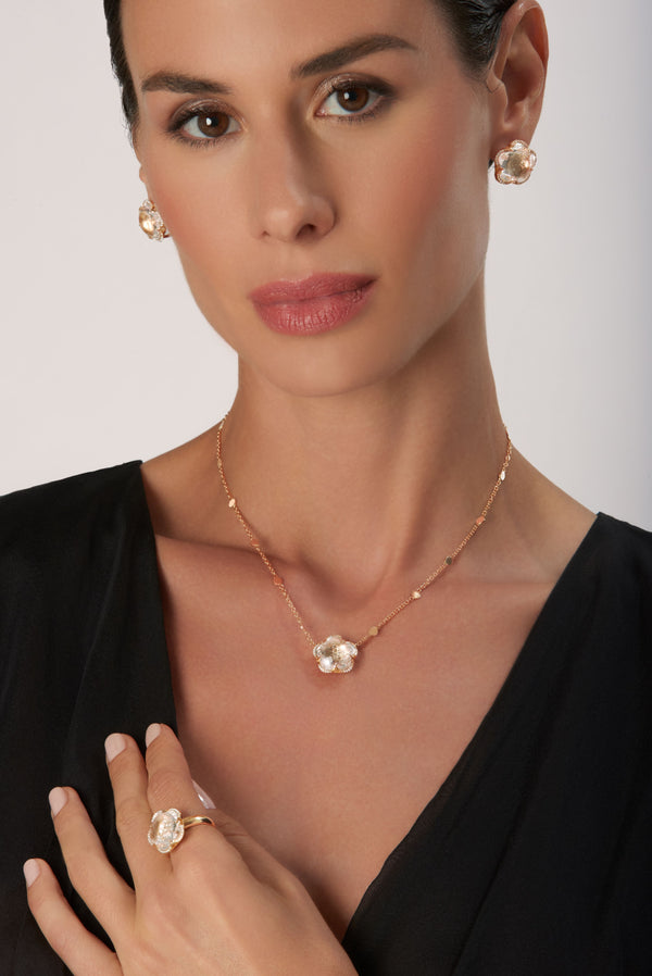 Necklace, ring and earrings in 18k Rose Gold with Rock Crystal, White and Champagne Diamonds on model wearing black dress