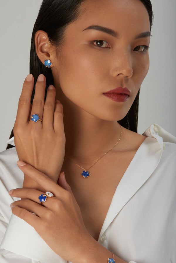 Model posing wearing a necklace, earring, ring, and bracelet from Pasquale Bruni's Petit Joli collection