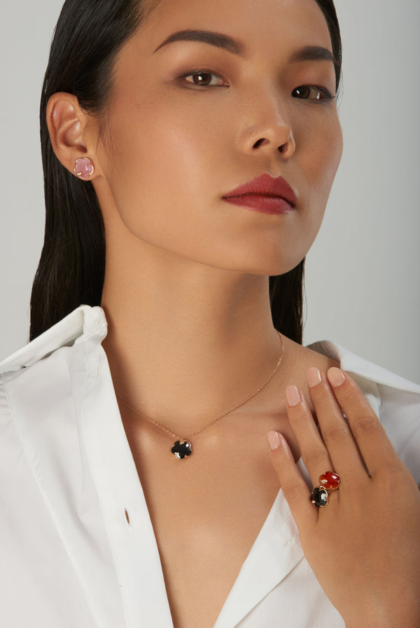 Necklace, earrings and rings with onyx and white and champagne diamonds on model in white shirt