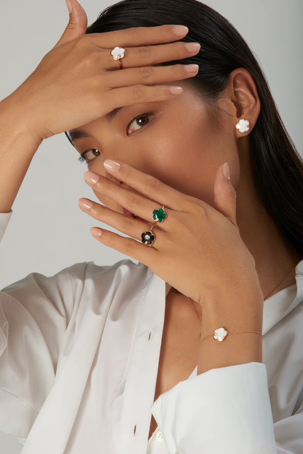 Earrings, rings, and bracelet in 18k rose gold with pearl of the moon gem made of mother of pearl and white moonstone and white diamonds on model