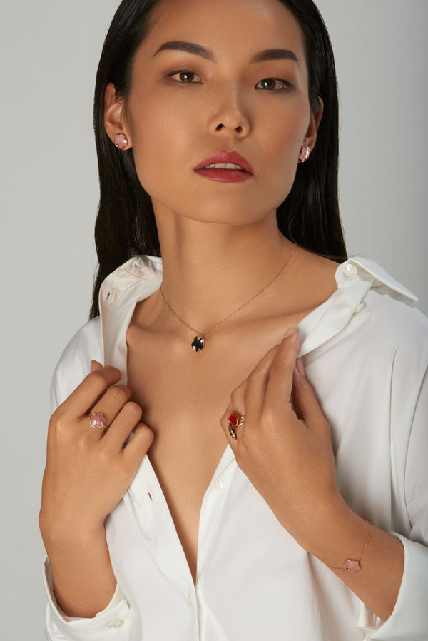 Model posing wearing a necklace, earring, ring, and bracelet from Pasquale Bruni's Petit Joli collection.