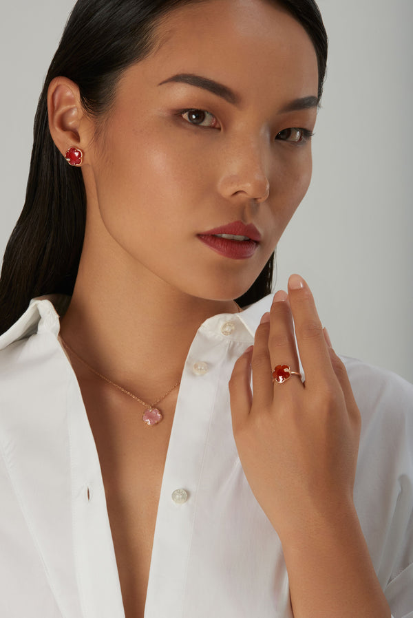 Necklace, ring and earring in 18k rose gold with carnelian and diamonds on model in white shirt