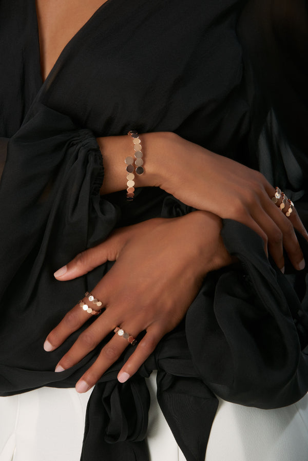 Rings and bracelet in 18k Rose Gold with Diamonds on model wearing a black blouse