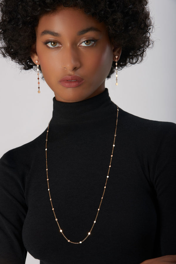Chain and earrings in 18k Rose Gold on model wearing black turtleneck