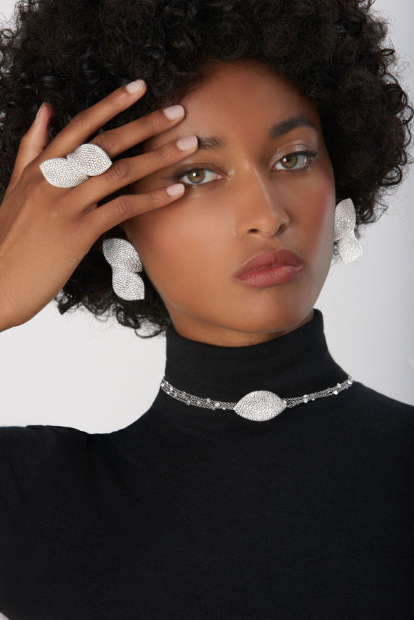 Sautoir, ring and earrings in 18k White Gold with White Diamonds on model waring black turtleneck