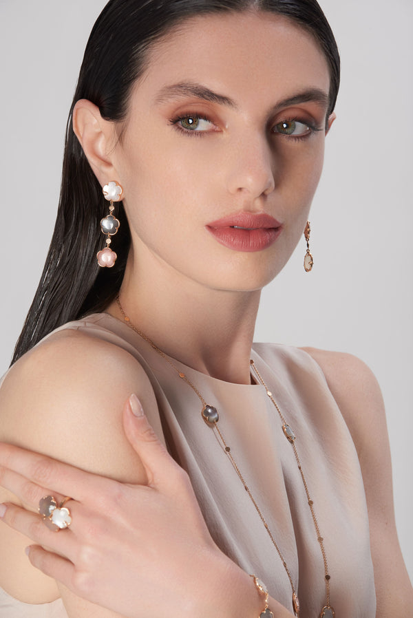 Necklace, earrings and ring in 18k rose gold with colored gemstones on model