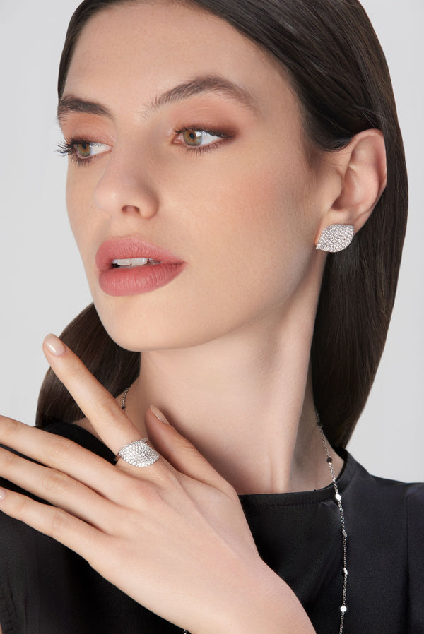Earrings and ring with diamonds on model wearing black dress