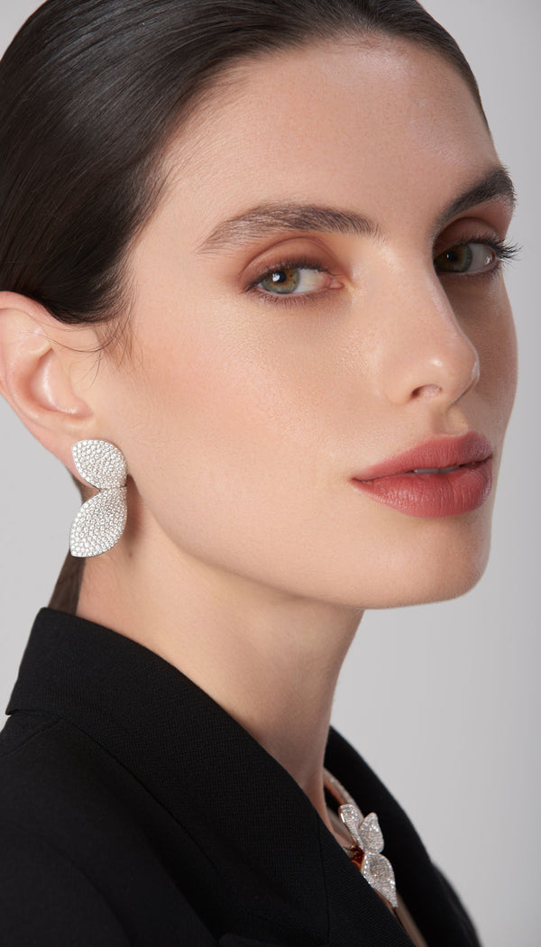 Earrings in 18k white gold with diamonds worn by model in a black blazer