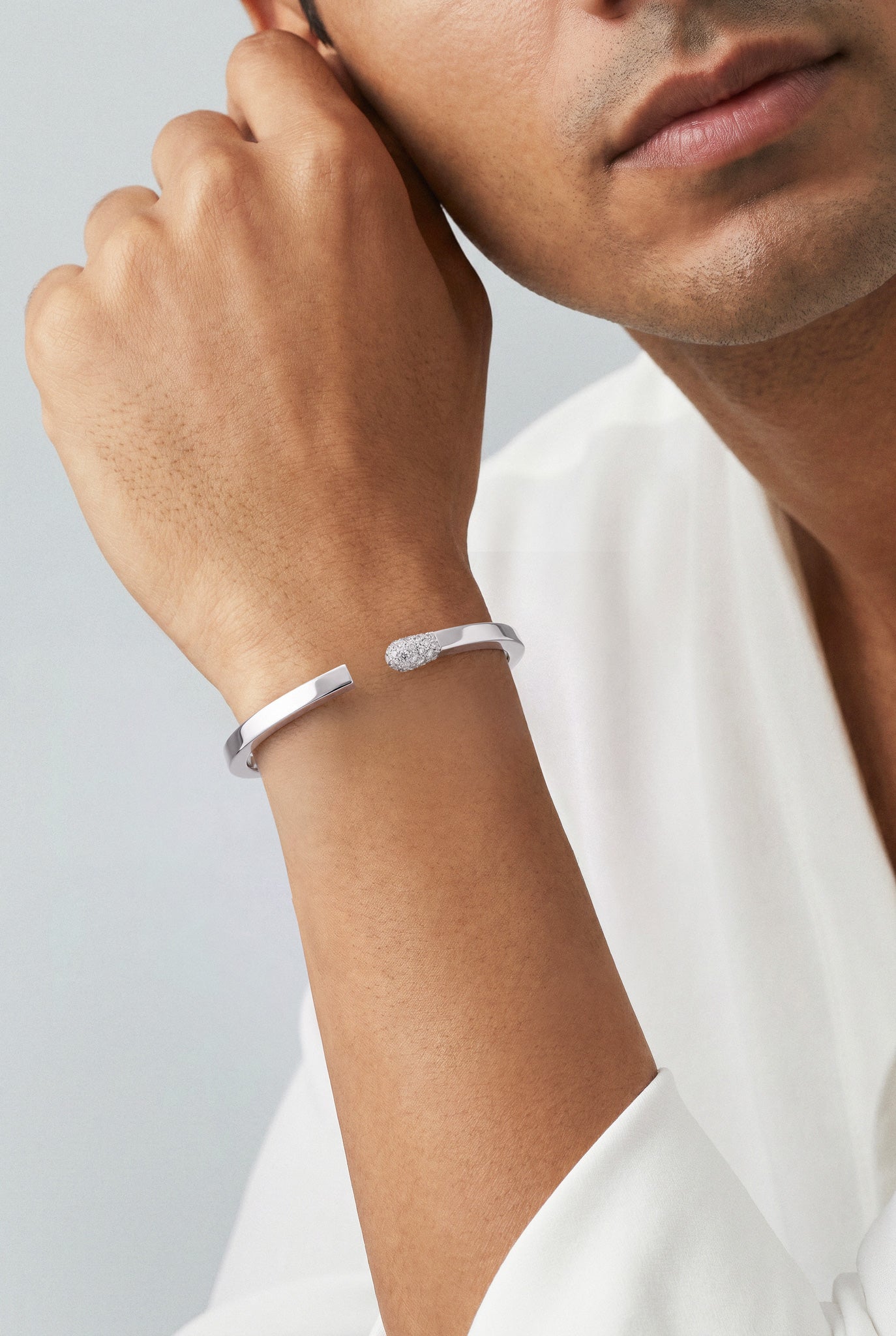 Model wearing a white shirt and a Bracelet in 18k White Gold with White diamonds