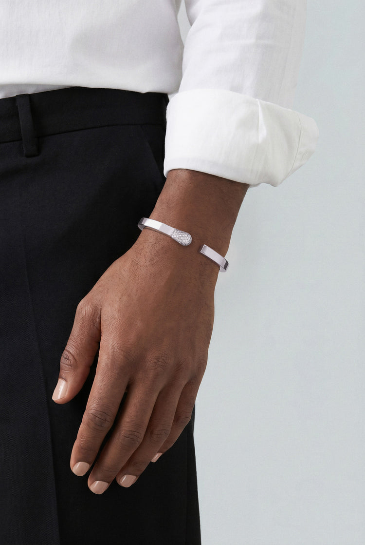 Model wearing a Bracelet in 18k White Gold with White Diamonds and a white shirt and black pants