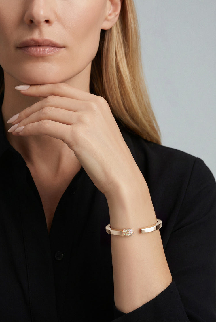 Model wearing a Bracelet in 18k Rose Gold with White and Champagne diamonds and a black shirt