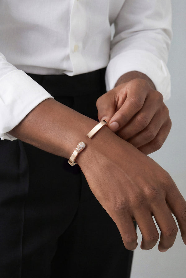 Model wearing a Bracelet in 18k Rose Gold with White and Champagne diamonds and a white shirt