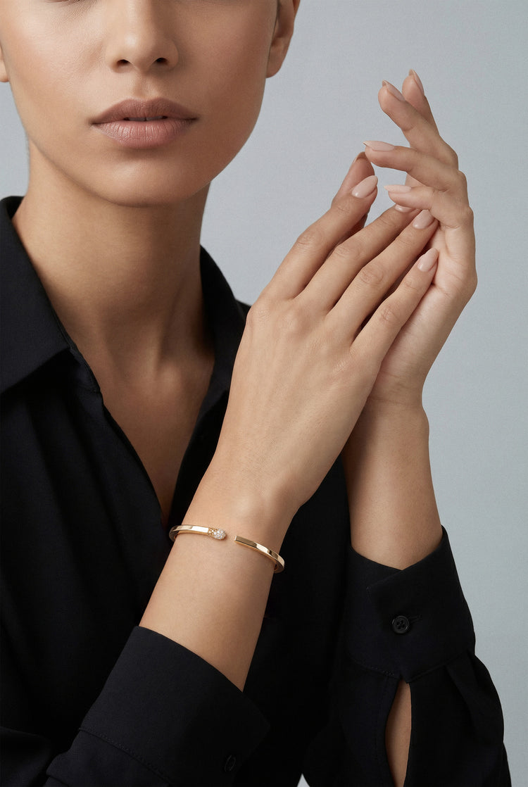 Model wearing a Bracelet in 18k Rose Gold with White and Champagne diamonds and a black shirt