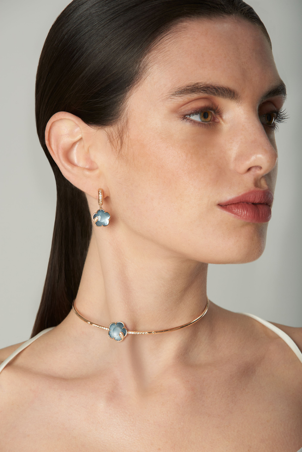Choker and earrings in 18k rose gold with blue gemstones and diamonds on model in white silk strap dress