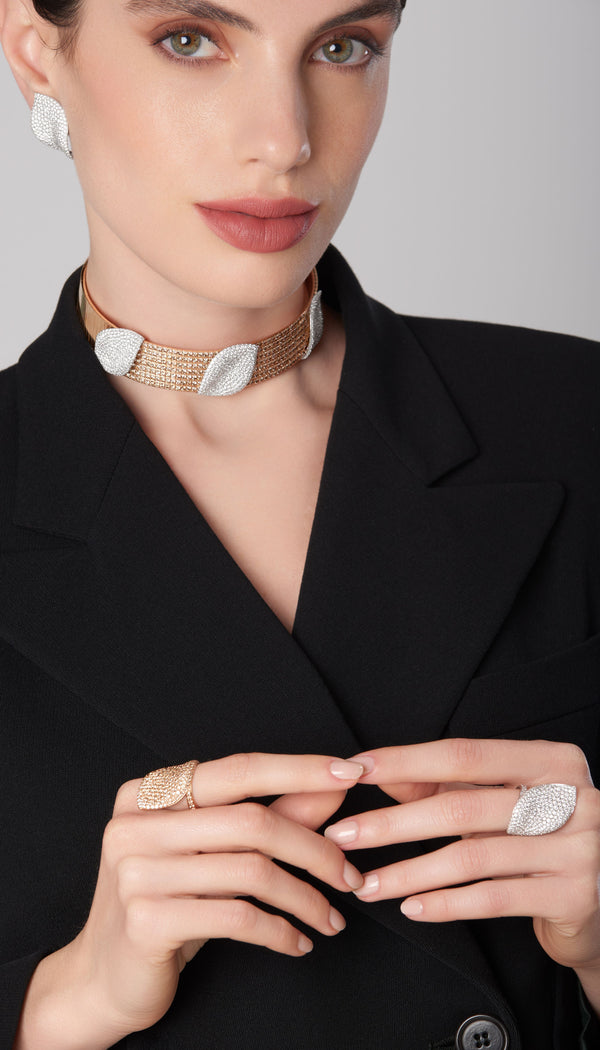 Choker, rings and earrings in 18k white and rose gold with diamonds on model in black attire