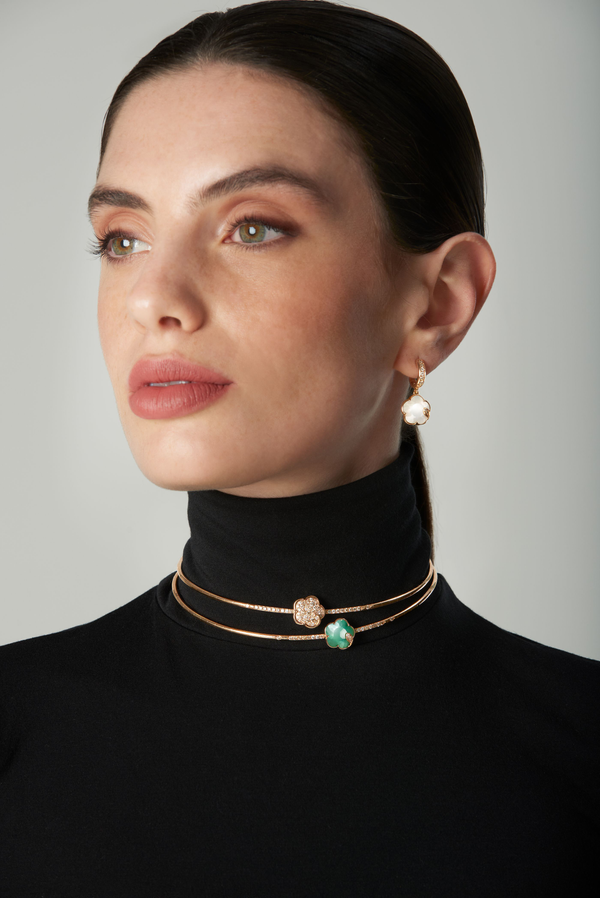 Choker and earrings in 18k rose gold with gem pearl and emerald and diamonds on model wearing turtleneck