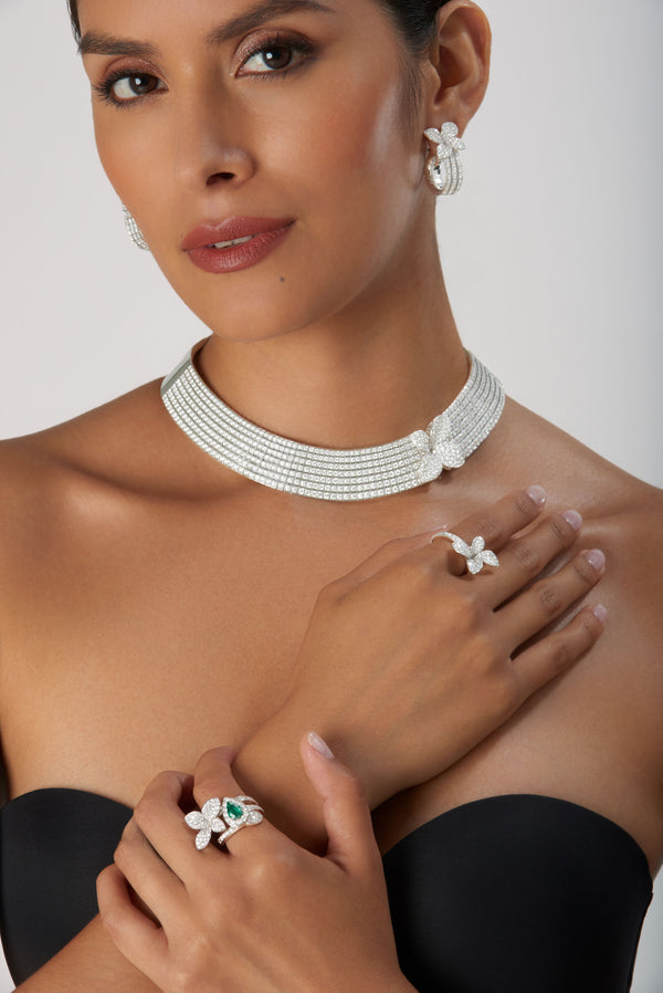 Necklace, earrings and rings in 18k white gold with diamonds on model in black strapless dress