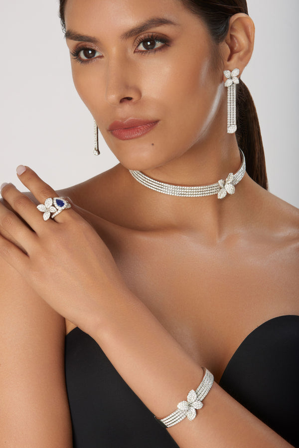 Earrings, ring, choker in 18k white gold with diamonds and sapphires on model