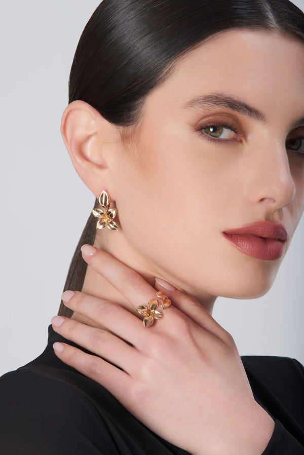 Earrings and ring in 18k rose gold with diamonds on model in black blouse