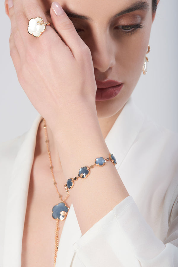 Bracelet in 18k rose gold with blue gemstones and diamonds and ring in 18k with pearl gem and diamonds