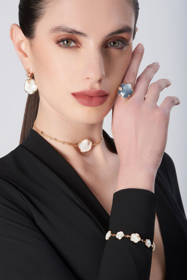 Model wearing earrings, necklace, ring, and bracelet in 18k gold with Pearl of The Moon Gem and Diamonds, with a black blouse