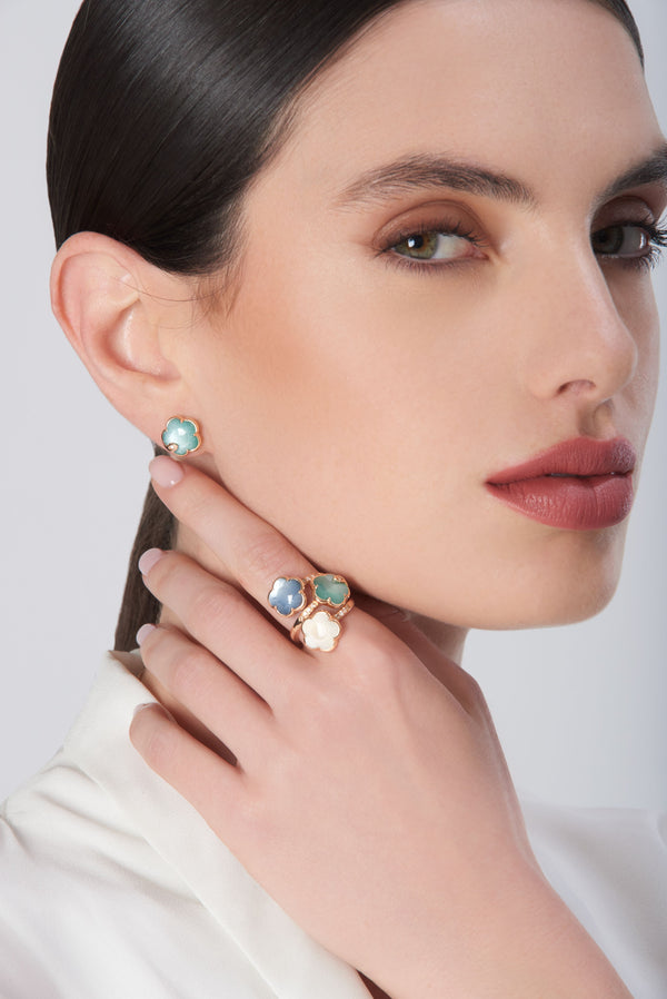 Earrings and ring in 18k rose gold with colored gemstones and diamonds on model in white blouse