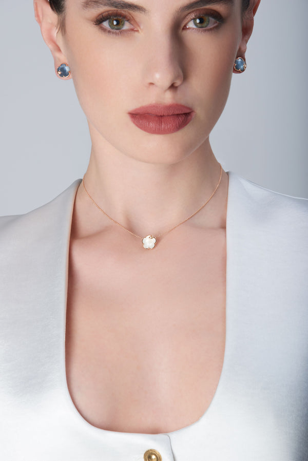 Earrings in 18k rose gold with blue gemstone and diamonds and necklace  with mother of pearl gemstone and diamonds on model in white blouse