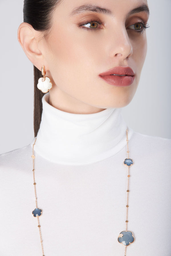 Earrings and necklace in 18k Rose Gold with coloured gemstones and diamonds on model in white turtleneck