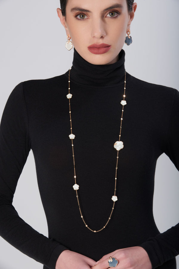 Woman in black turtleneck wearing sautoir in 18k rose gold with pearl of the moon gem and diamonds, matching earrings and ring