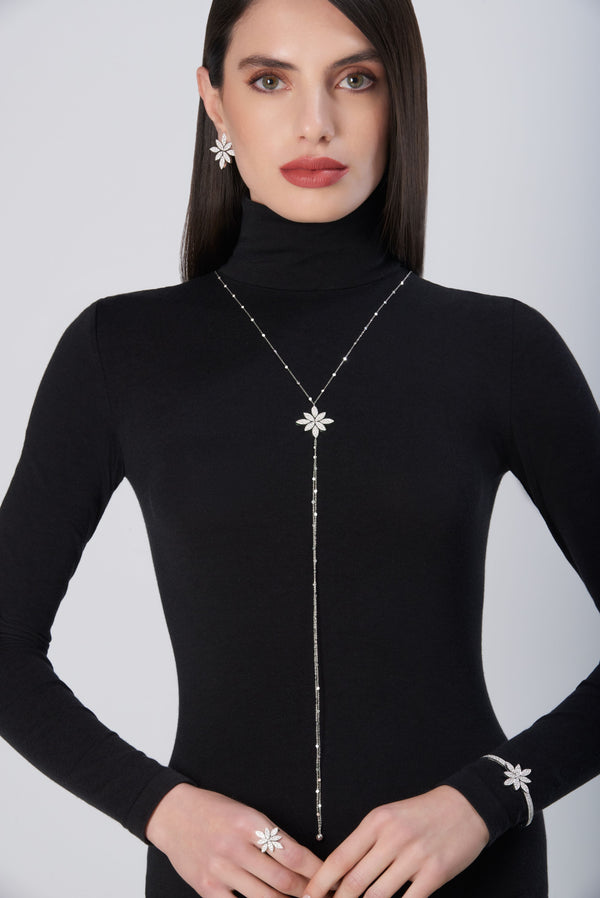 Sautoir, bracelet, ring and earrings in 18k White Gold with White Diamonds on model wearing black turtleneck
